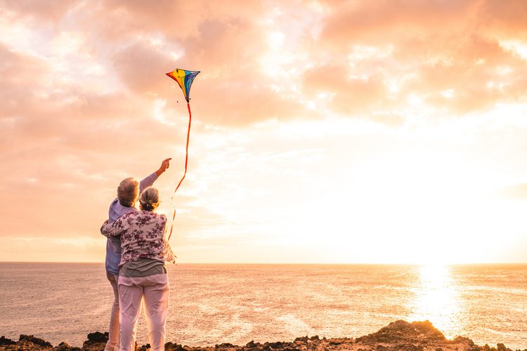 Elderly Couple at Beach with Kites